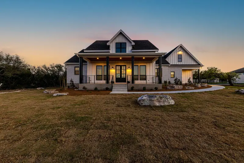 Exterior at dusk, Farmhouse Hill Country Retreat (RenovatePros project)