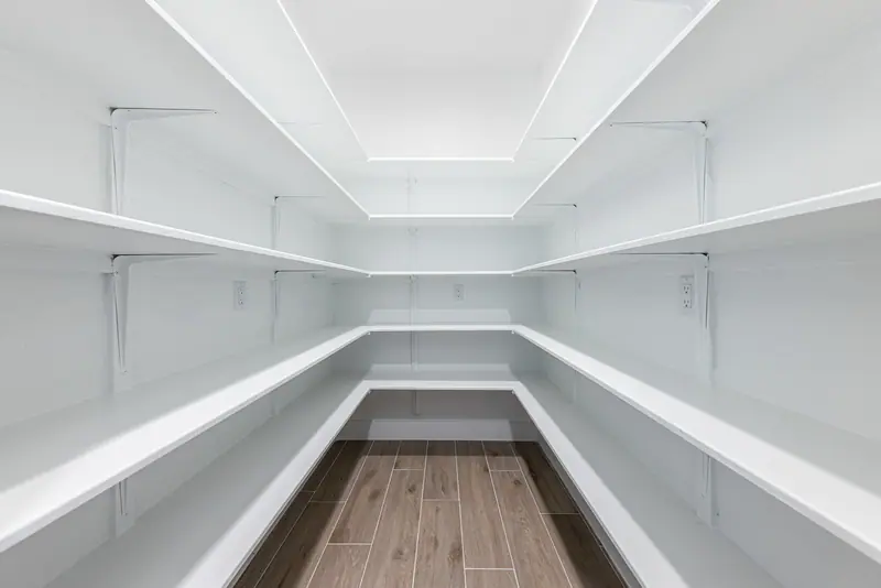 Walk-in pantry with wraparound shelves, Farmhouse Hill Country Retreat (RenovatePros project)