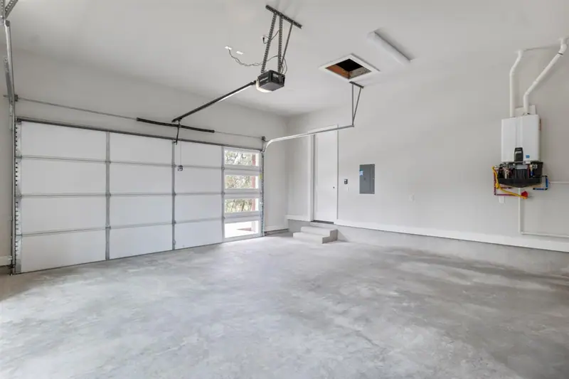 Garage with a glass-panel garage door, Round Mountain Modern Farmhouse (RenovatePros project)