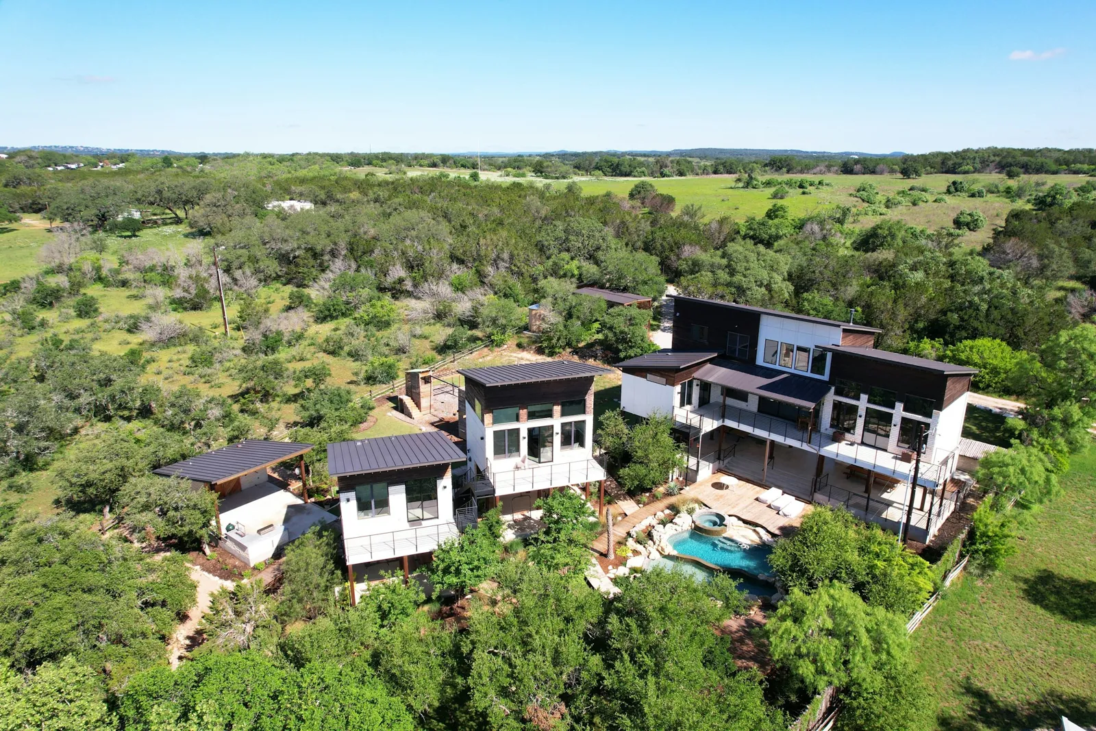 Aerial view of the main house and two guest houses, Spicewood Lake Retreat (RenovatePros project)