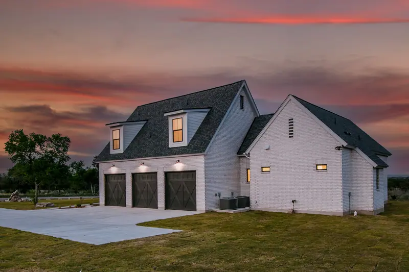 Exterior at dusk, Spicewood Modern Farmhouse (RenovatePros project)