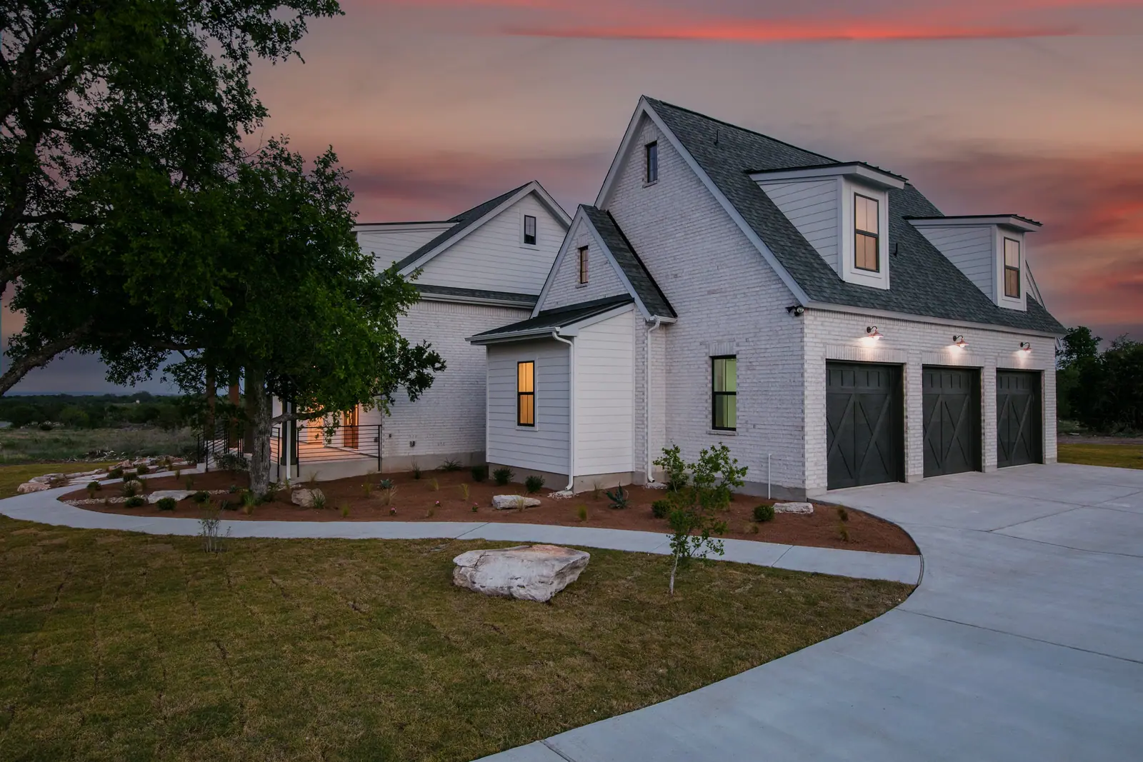 Exterior at dusk, Spicewood Modern Farmhouse (RenovatePros project)