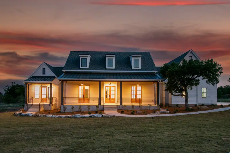 Exterior at dusk, Spicewood Modern Farmhouse (RenovatePros project)