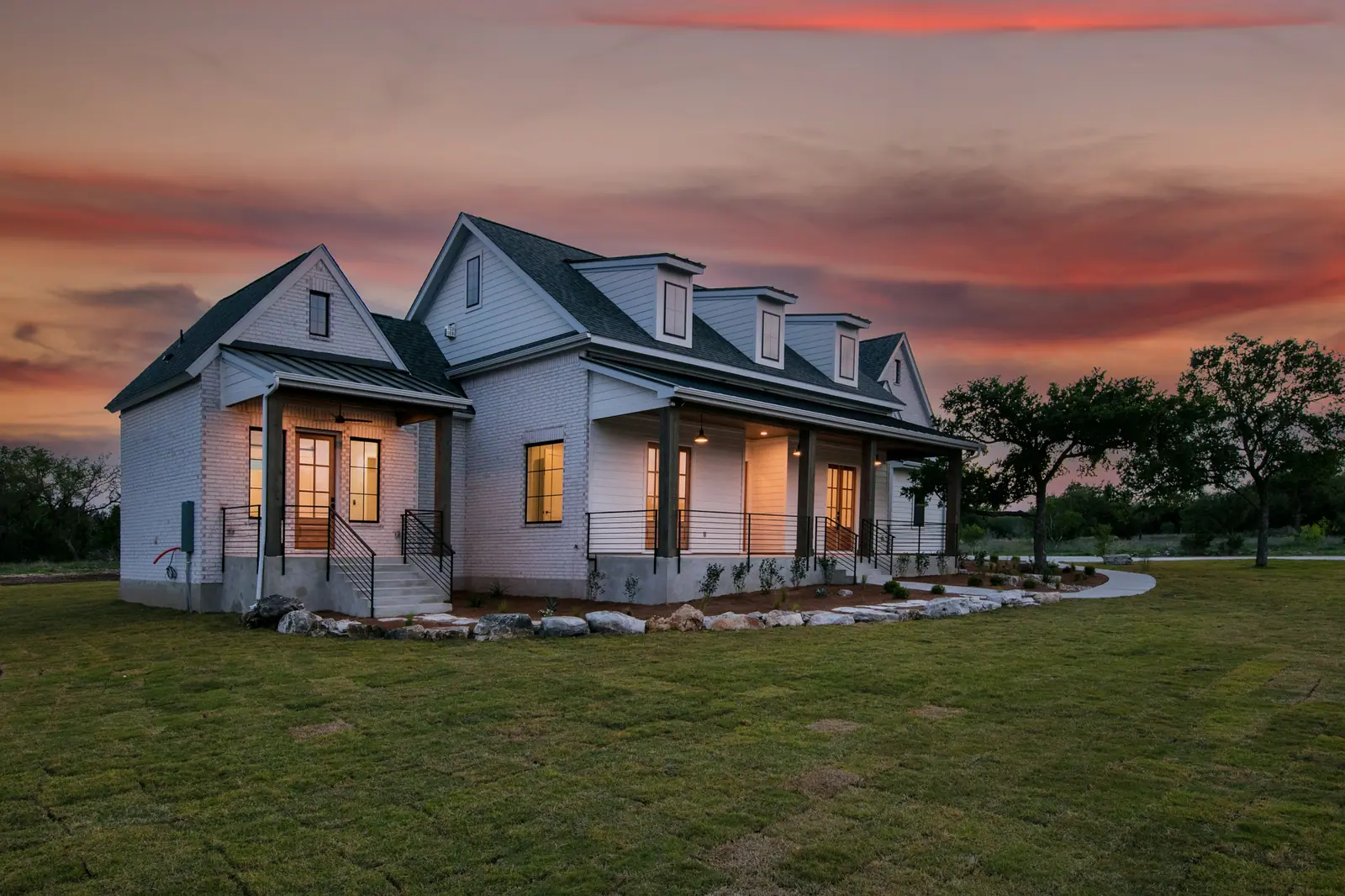 Exterior at dusk, Spicewood Modern Farmhouse (RenovatePros project)