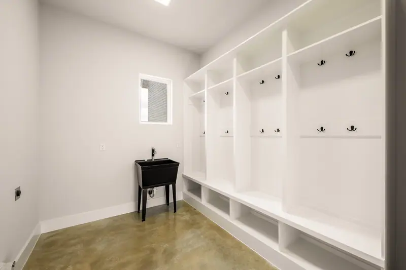 Mudroom with built-in lockers and a utility sink, Spicewood Modern Farmhouse (RenovatePros project)