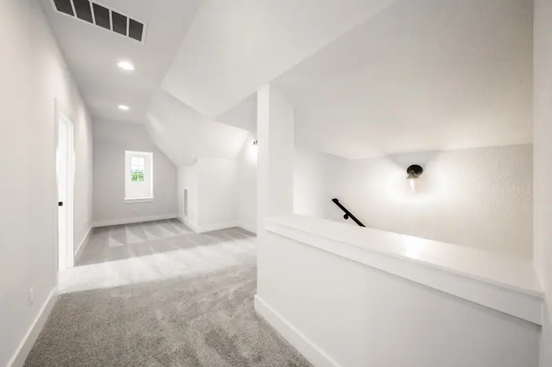 Upstairs landing with carpet and a stair railing, Spicewood Modern Farmhouse (RenovatePros project)