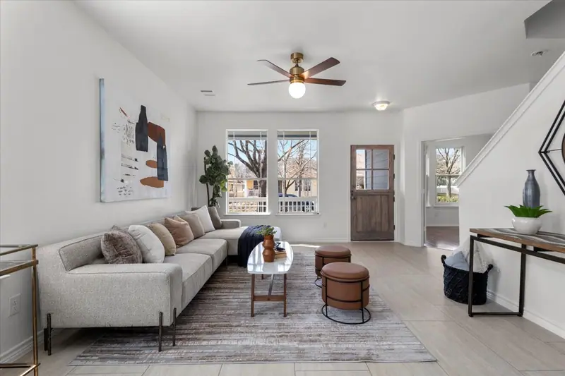 Living room with a sectional sofa, front door and staircase, Two-Story Home Remodel, 2026 (RenovatePros project)