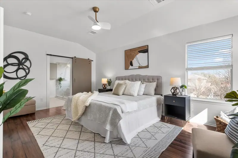 Primary bedroom with a barn door to the bathroom, Two-Story Home Remodel, 2026 (RenovatePros project)