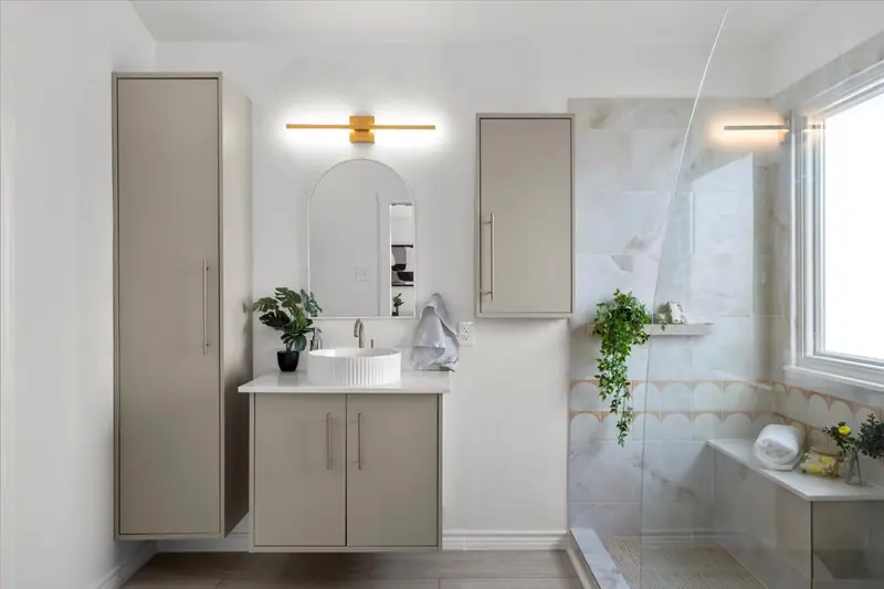 Primary bathroom with a floating vanity, tall cabinets and a glass walk-in shower, Two-Story Home Remodel, 2026 (RenovatePros project)